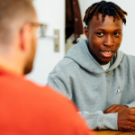Support worker talking to young person